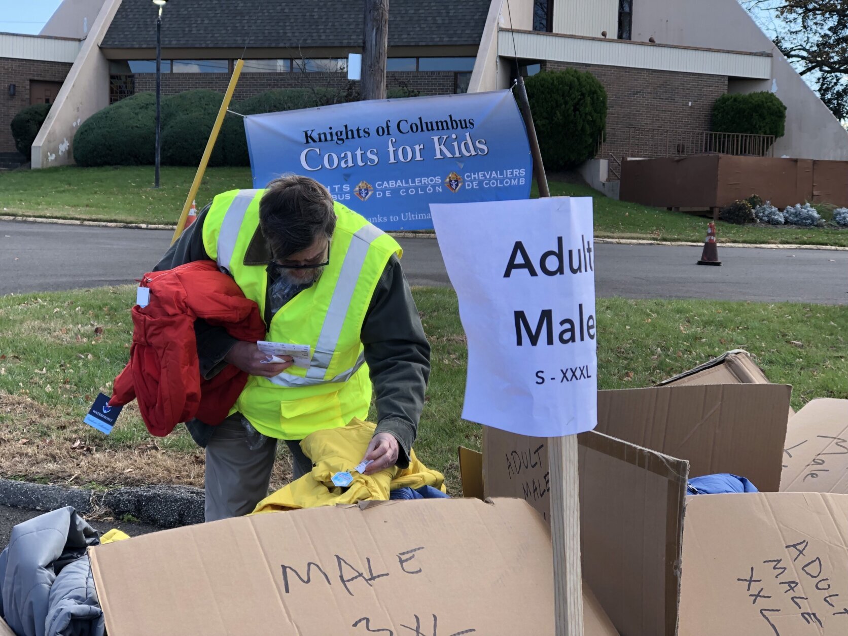 <p>Volunteers distribute coats Friday outside Our Lady of Perpetual Help Church in Southeast D.C. (WTOP/Kate Ryan)</p>
