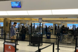 At Reagan National Airport, if you’re dropped off on the top level, you will go down a set of new escalators to the new security checkpoints. (WTOP/John Domen)