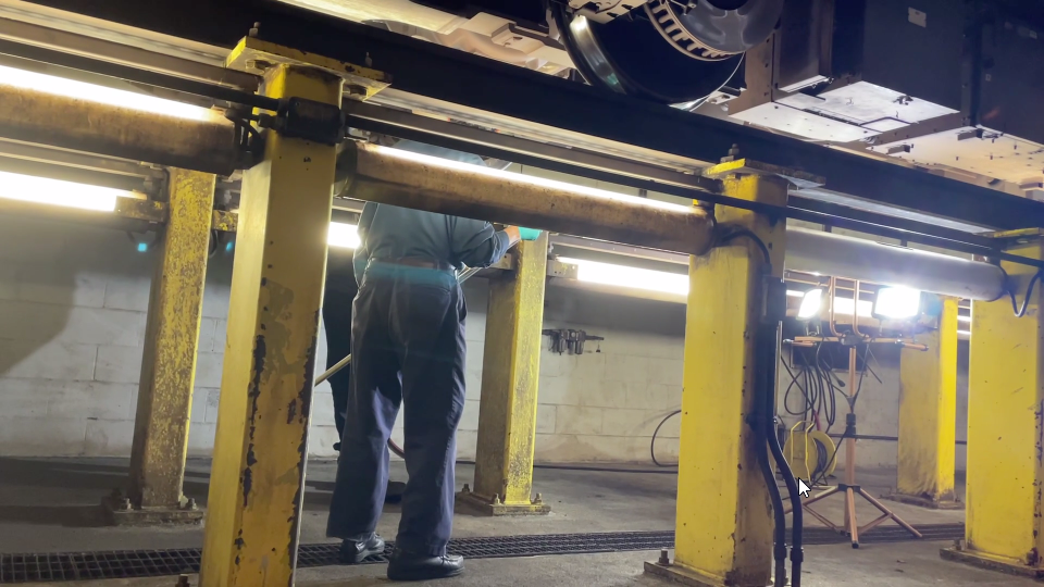 <p>While underneath a 7000-series train car, a Metro crew inspects its wheel set assembly. Moving the train over a &#8220;pit&#8221; allows workers to get underneath. Removing it to inspect would be &#8220;extremely time-consuming,&#8221; Wiedefeld said.</p>
