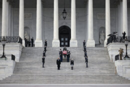 Sergeant at Arms for the Senate Karen Gibson, center right, and Sergeant at Arms for the House of Representatives William Walker, center left, lead a military honor guard as they carry the flag-draped casket of former Sen. Bob Dole of Kansas, from the U.S. Capitol in Washington, Friday, Dec. 10, 2021, after lying in state. (Anna Moneymaker/Pool via AP)