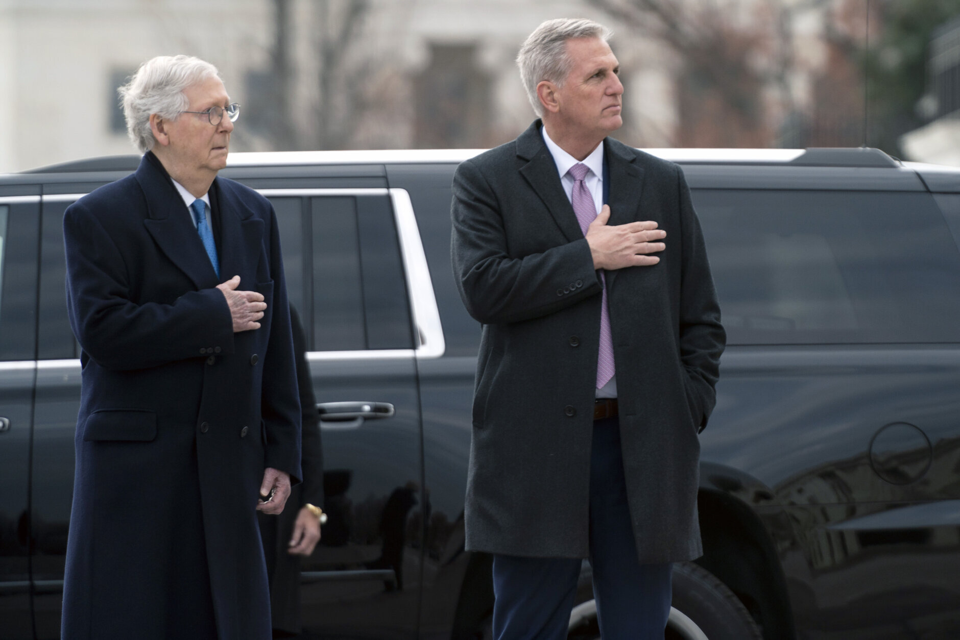 Senate Minority Leader Mitch McConnell of Ky., and House Minority Leader Kevin McCarthy of Calif., watch as a military honor guard carries the flag-draped casket of former Sen. Bob Dole from the U.S. Capitol in Washington, Friday, Dec. 10, 2021, where he had lied in state on Thursday and over night.  (Greg Nash/Pool via AP)