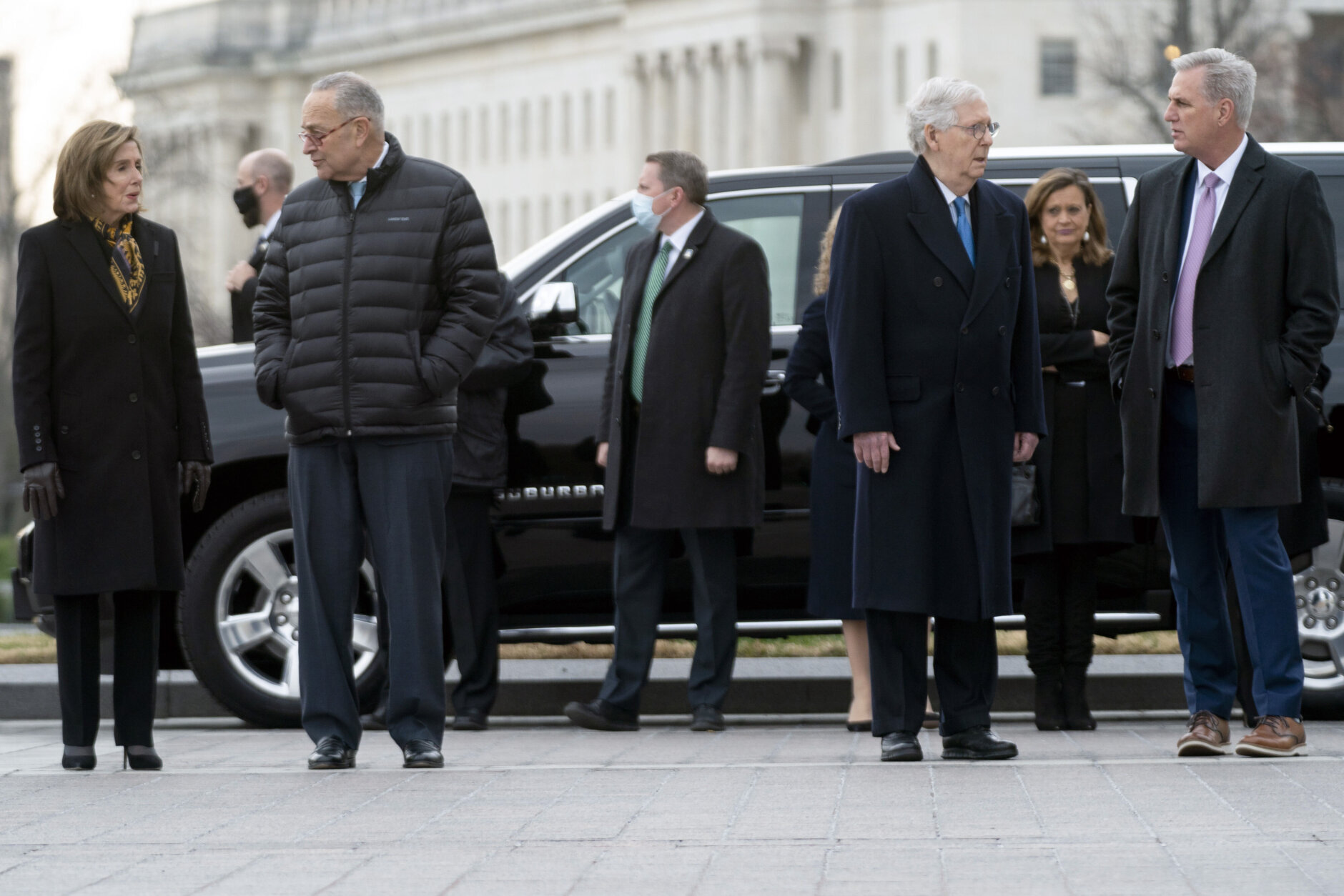 From left, House Speaker Nancy Pelosi of Calif., Senate Majority Leader Chuck Schumer of N.Y., Senate Minority Leader Mitch McConnell of Ky., and House Minority Leader Kevin McCarthy of Calif., arrive to watch a military honor guard carry the flag-draped casket of former Sen. Bob Dole from the U.S. Capitol in Washington, Friday, Dec. 10, 2021, where he had lied in state on Thursday and over night.  (Greg Nash/Pool via AP)