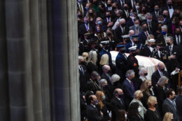 The casket of former Sen. Bob Dole of Kansas, is carried during a funeral service at the Washington National Cathedral, Friday, Dec. 10, 2021, in Washington. (AP Photo/Evan Vucci)
