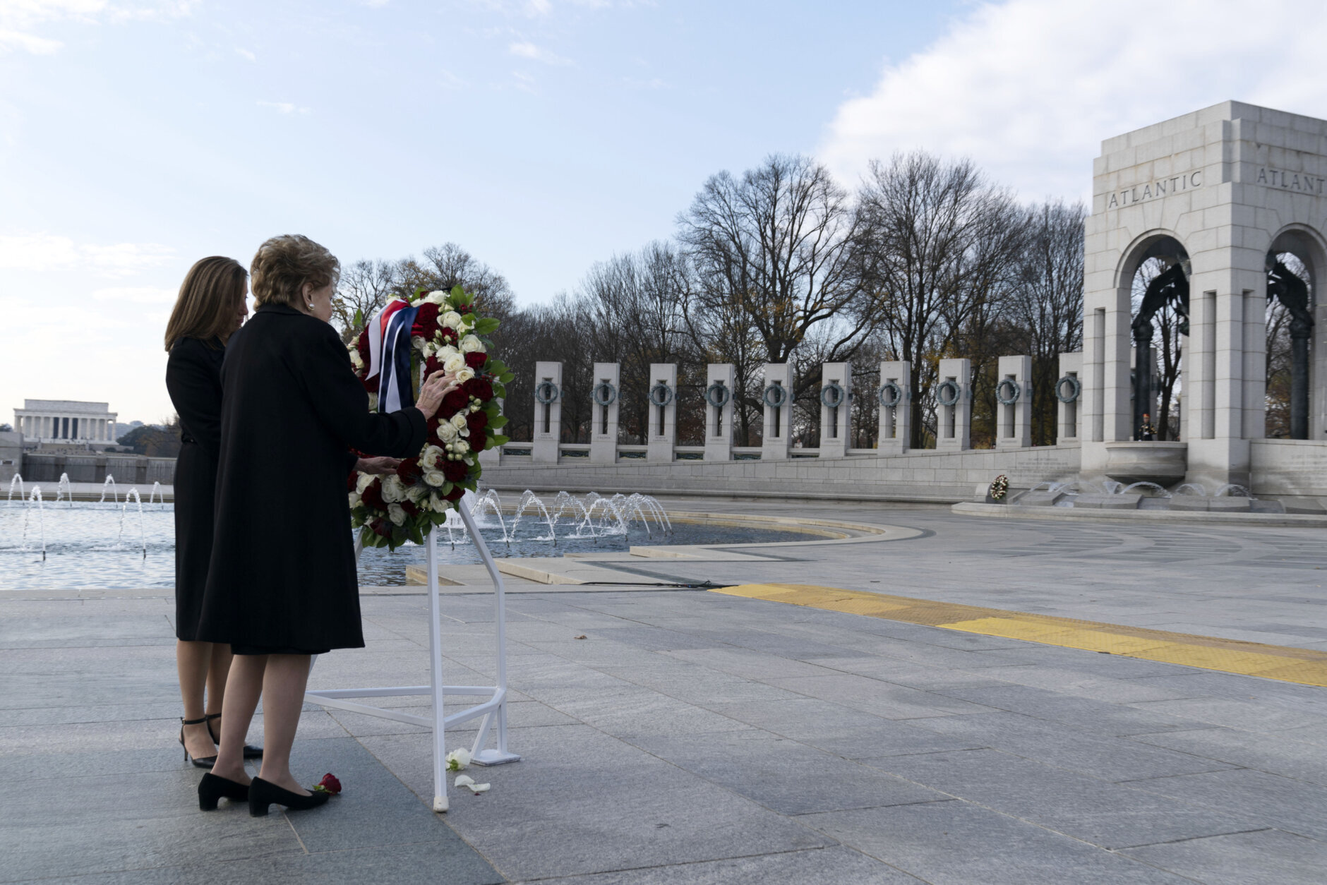 Former Sen. Elizabeth Dole with her daughter Robin Dole, lay a floral wreath during a ceremony in honor of her husband former Sen. Bob Dole, R-Kan., at the National World War II Memorial, on Friday, Dec. 10, 2021, in Washington. (AP Photo/Jose Luis Magana)