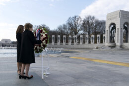 Former Sen. Elizabeth Dole with her daughter Robin Dole, lay a floral wreath during a ceremony in honor of her husband former Sen. Bob Dole, R-Kan., at the National World War II Memorial, on Friday, Dec. 10, 2021, in Washington. (AP Photo/Jose Luis Magana)