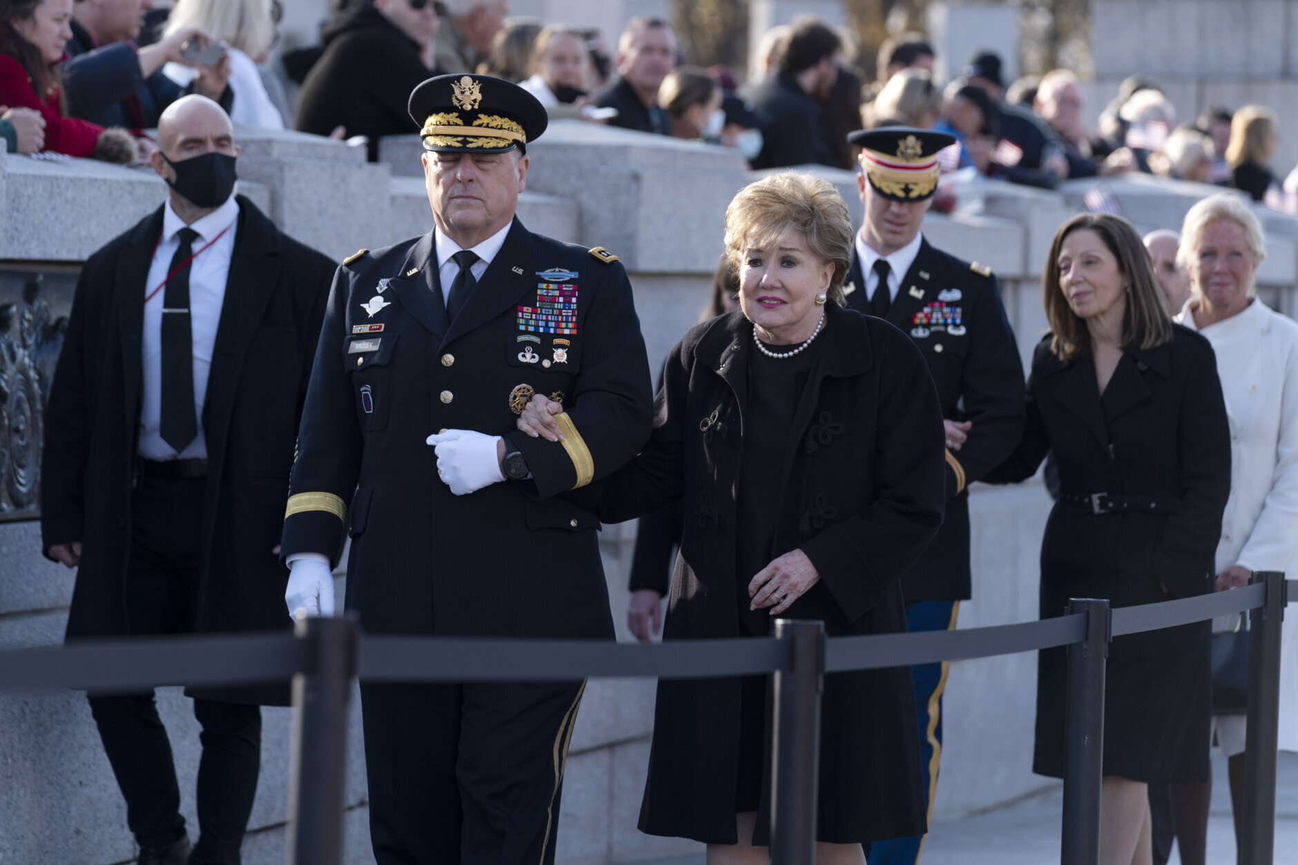 Chairman of the Joint Chiefs of Staff Gen. Mark Milley walks with former Sen. Elizabeth Dole and another member of the military walks with Robin Dole, second from right, as leave after a ceremony held in honor of former Sen. Bob Dole, R-Kan., at the National World War II Memorial, on Friday, Dec. 10, 2021, in Washington. (AP Photo/Jose Luis Magana)
