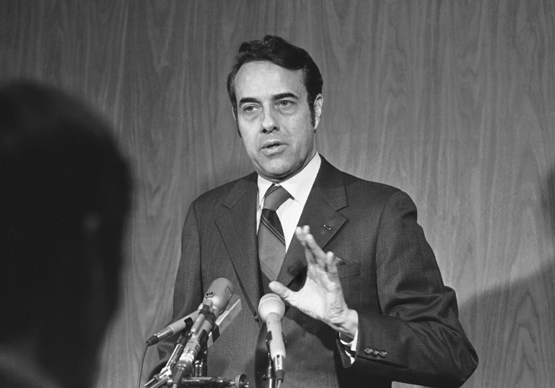 Sen. Robert Dole, R-Kan., discussed Senate security at a news conference March 9, 1971 in St. Louis, after an explosion in the U.S. Capitol. Dole said senators are vulnerable to anyone who might throw a bomb or even "a Wilkie button" from the open gallery. (AP Photo/Fred  Waters)