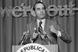 Sen. Robert Dole of Kansas, a former GOP national chairman, addresses the Republican Leadership Conference in Washington Friday, March 7, 1975. Dole said, "at least in terms of numbers the Republican Party is today in worse shape than it has ever been before in its history." The full sign behind him reads "we're out to win". (AP Photo)