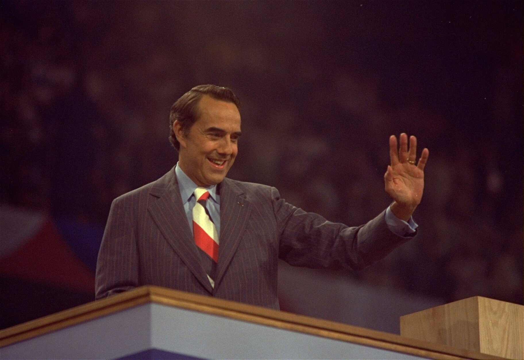 Sen. Robert Dole (R-Kansas) shown speaking and waving to crowds at the National Republican Convention in Kemper Arena, Kansas City, Mo. on August 19, 1976. (AP PHoto)
