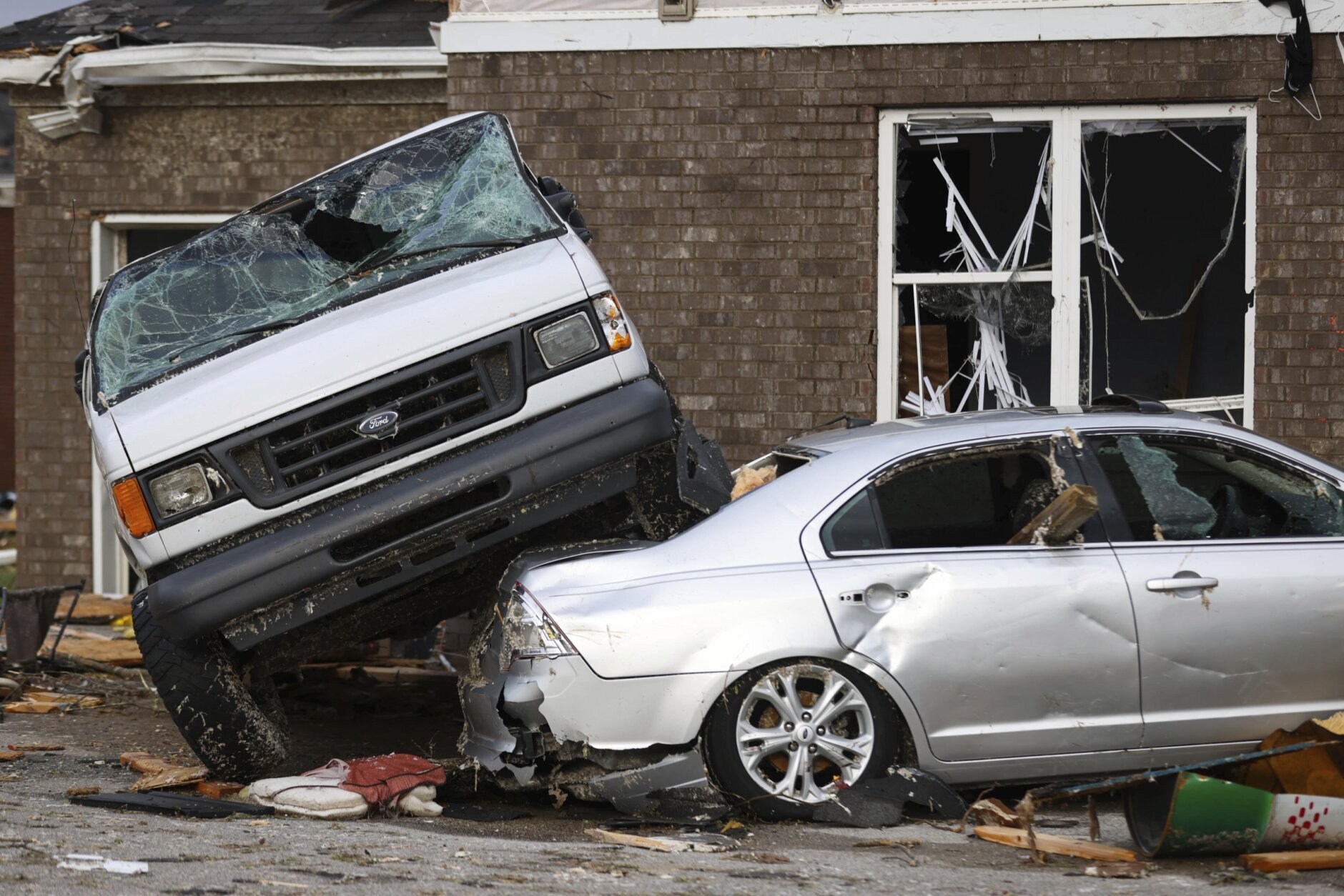 A car wrecked by a tornado sits on top of another car in Bowling Green, Ky., Saturday, Dec. 11, 2021. A monstrous tornado killed dozens of people in Kentucky and the toll was climbing Saturday after severe weather ripped through at least five states, leaving widespread devastation. (AP Photo/Michael Clubb)