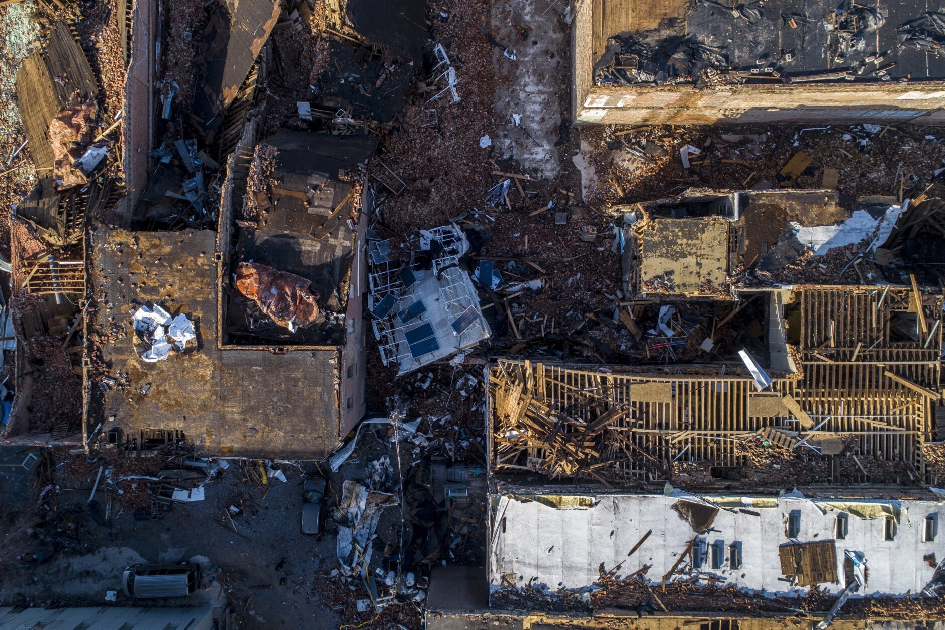 In this photo taken by a drone, buildings are demolished in downtown Mayfield, Ky., on Saturday, Dec. 11, 2021, after a tornado traveled through the region Friday night. A monstrous tornado killed dozens of people in Kentucky and the toll was climbing Saturday after severe weather ripped through at least five states, leaving widespread devastation. (Ryan C. Hermens/Lexington Herald-Leader via AP)
