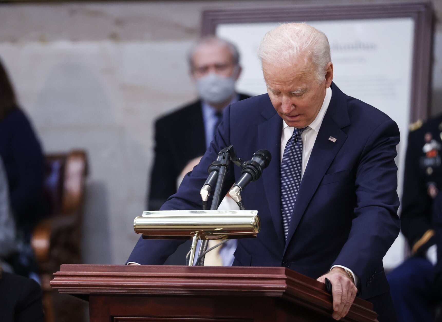 President Joe Biden speaks near the casket of former Sen. Bob Dole, who died on Sunday, during a congressional ceremony to honor Dole, who lies in state in the U.S. Capitol Rotunda in Washington, Thursday, Dec. 9, 2021. (Jonathan Ernst/Pool via AP)