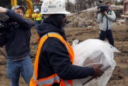 <p>Michael Spence, construction superintendent with Team Henry Enterprises, moves a box believed to be the 1887 time capsule that was put under Confederate Gen. Robert E. Lee statue&#8217;s pedestal and recovered on Monday, Dec. 27, 2021, in Richmond, Va. (Eva Russo/Richmond Times-Dispatch via AP)</p>
