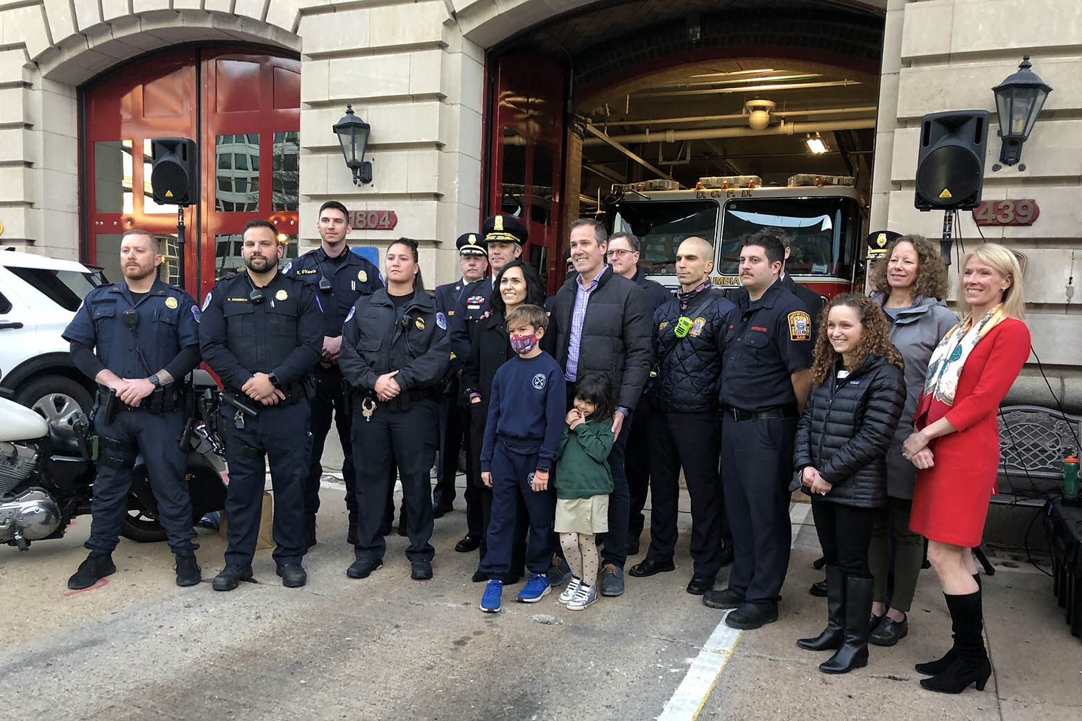 Group in front of firehouse