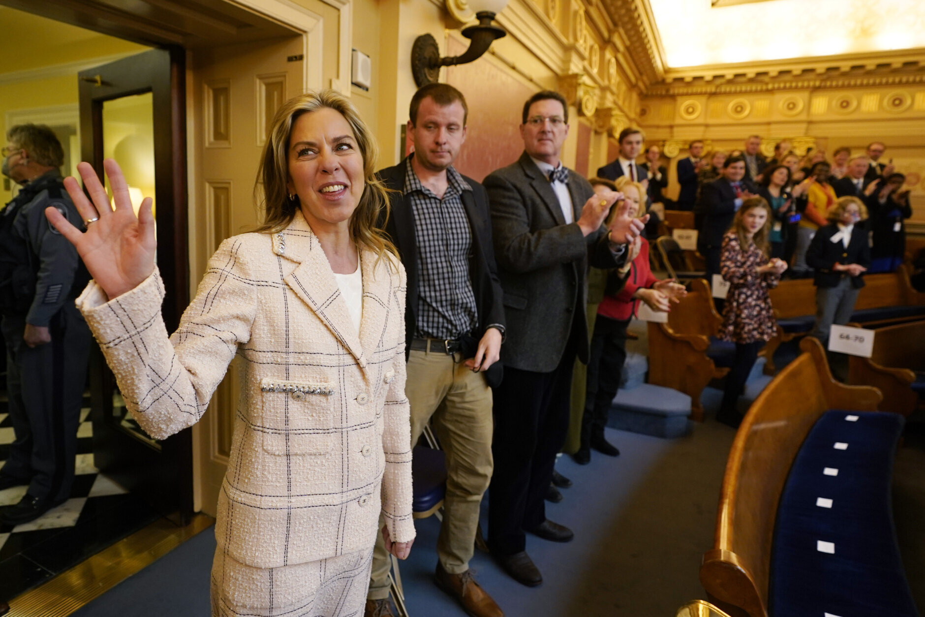 Virginia first lady, Suzanne Youngkin, waves as she is introduced in the Gallery as she arrives for her husband's State of the Commonwealth address before a joint session of the Virginia General Assembly in the House chambers at the Capitol Monday Jan. 17, 2022, in Richmond, Va. (AP Photo/Steve Helber)