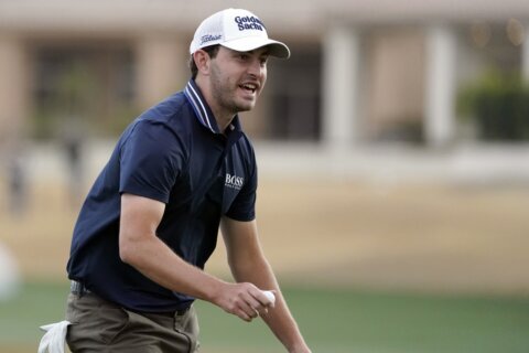 Cantlay fights through gusting wind, leads American Express