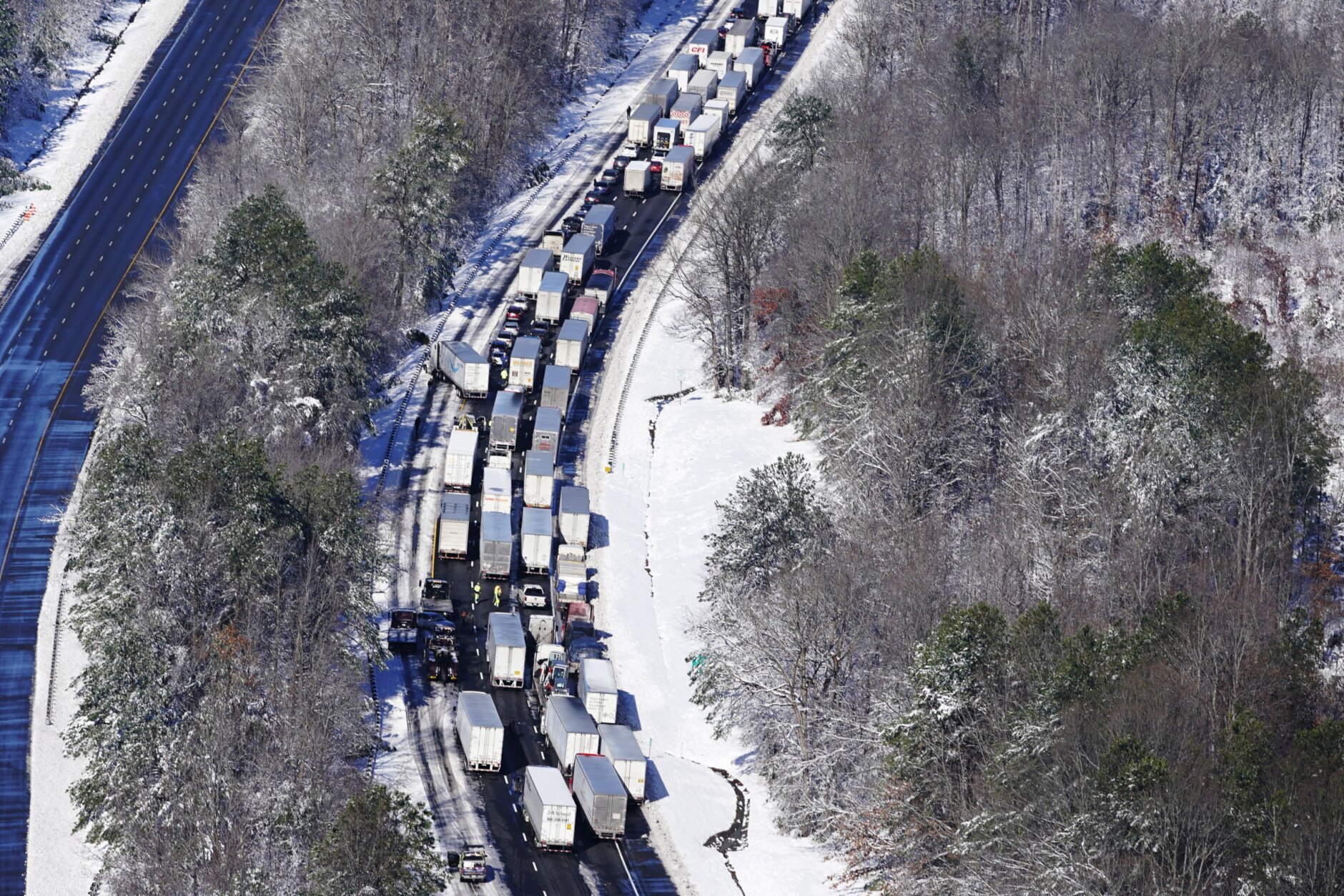 <h3>Blindsided and snow-bound on I-95</h3>
<p>The most fateful weather event of 2022 will be remembered not for its meteorological ranking but for its disastrous impact on traffic.</p>
<p>A well-forecast snowstorm on Jan. 3 produced a broad swath of foot-deep snow across Stafford County, Spotsylvania County and Fredericksburg in Virginia. About half a foot fell near the Capital Beltway, with lesser amounts to the north. It was the kind of winter storm that passes through the area once every three to five years.</p>
<p>In the face of Winter Storm Warnings, too many people decided to drive that Monday morning and many of them incurred hours-long traffic delays. Traffic seized on the snow-covered Beltway near the Woodrow Wilson Bridge. Some drivers idled on Route 50 near Annapolis, Maryland, for more than four hours.</p>
<p>The words &#8220;disaster&#8221; and &#8220;nightmare&#8221; are often inappropriately used describe to commonplace traffic backups, but the agony and potentially life-threatening conditions that drivers endured on Jan. 3 and 4 were truly nightmarish south of Washington.</p>
<p>On Interstate 95 in northern Virginia, a volatile combination of heavy New Year&#8217;s weekend traffic and extreme snowfall rates led to one of the worst traffic disasters in recent history. One by one, drivers of big trucks and small cars began losing traction and blocking lanes.</p>
<p>Snow, falling at rates exceeding two inches per hour, rapidly piled up between large clusters of disabled vehicles, with long segments of the highway becoming impassable between Thornburg and Garrisonville.</p>
<p>The result was unprecedented — far worse than even the harrowing traffic tales told after notorious snowstorms on Jan. 26, 2011 and March 9, 1999. Some drivers and passengers were <a href="https://wtop.com/traffic/2022/01/the-storm-paralyzed-traffic-on-some-roads/">marooned on I-95</a> for more than 24 hours, forced to spend the night on the dark highway without food, water or a bathroom. A 40 mile segment of I-95 was closed for nearly two days for the removal of disabled vehicles and ice.</p>
<p>The Virginia Department of Emergency Management, Virginia Department of Transportation and the Virginia State Police were criticized for their delayed response, poor coordination and &#8220;broader lack of situational awareness&#8221; in an <a href="https://wtop.com/virginia/2022/04/report-details-virginias-response-to-january-snow-storm-gridlock/">after-action report</a>. Virginia’s inspector general revealed additional glaring missteps in a <a href="https://wtop.com/virginia/2022/08/new-virginia-ig-audit-on-what-went-wrong-during-i-95-snowstorm-gridlock/">29-page audit</a>.</p>
<p>The shortcomings in the Commonwealth&#8217;s response exacerbated the inevitable. In a densely populated area, it is not the blockbuster blizzards but rather <a href="https://wtop.com/dc-transit/2022/01/when-it-comes-to-snow-stunned-traffic-its-all-about-fall-rates-bad-timing-and-poor-judgement/">underestimated snowstorms</a> yielding extreme snowfall rates that so often lead to calamitous travel conditions. If enough discretionary travel is postponed, essential personnel have room to maneuver and travel.</p>
