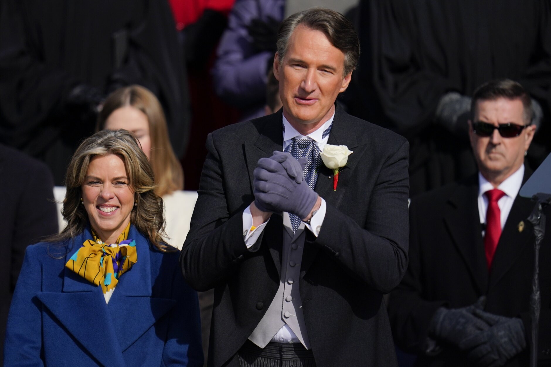 Gov. elect Glenn Youngkin with wife Suzanne Youngkin wave to the crowd before his inauguration ceremony, Saturday, Jan. 15, 2022, in Richmond, Va. (AP Photo/Julio Cortez)