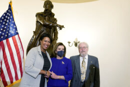 Speaker of the House Nancy Pelosi, D-Calif., center, Mayor Muriel Bowser, left, and artist Gordon Kray, right, during a ceremony unveiling a statue of Pierre L'Enfant, seen behind, Monday, Feb. 28, 2022, that was gifted by the District of Columbia, at the Capitol in Washington. (AP Photo/Mariam Zuhaib)