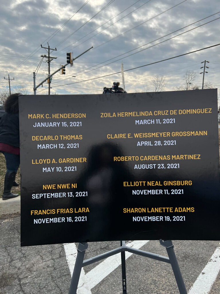 sign displays the names of the ten pedestrians killed in auto incidents