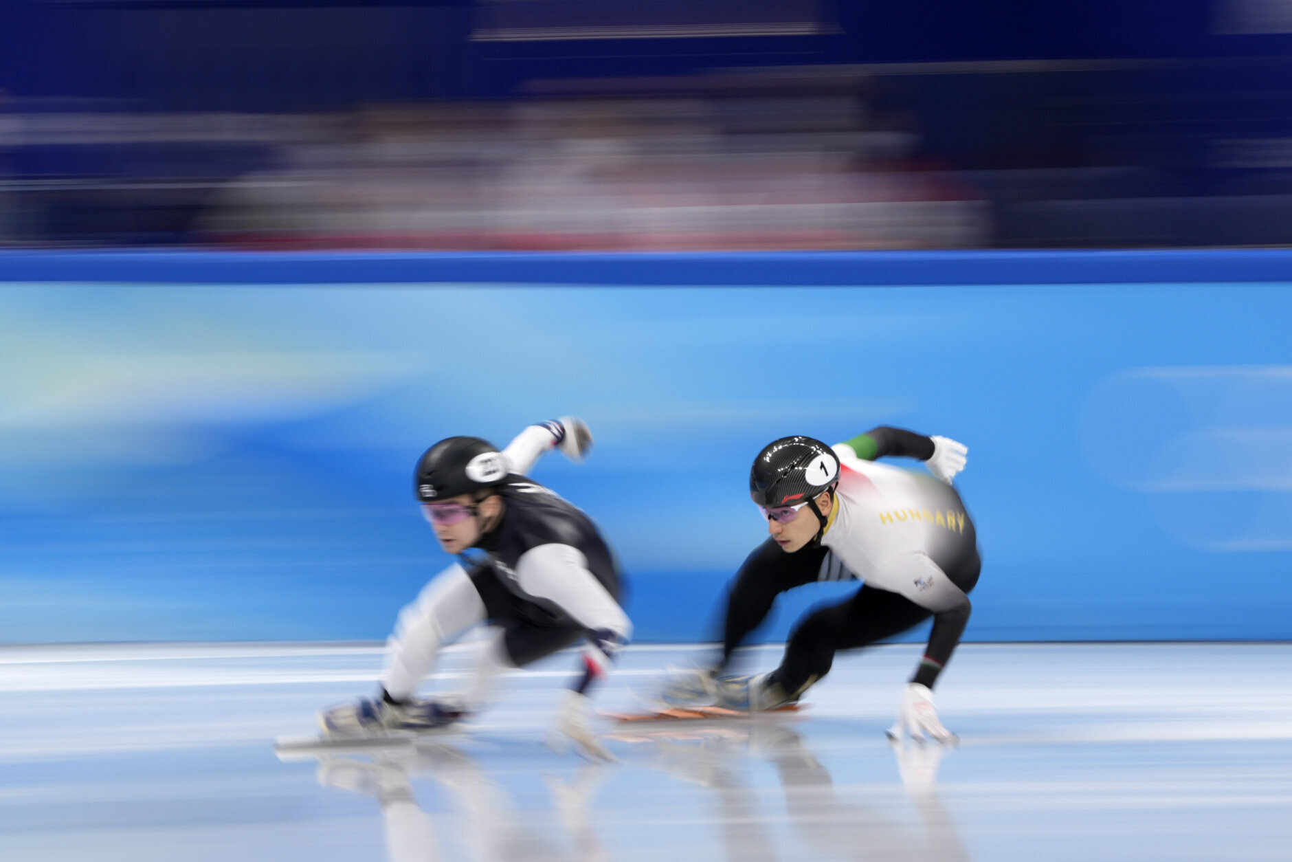 Andrew Heo, left, of the United States and Liu Shaoang of Hungary race in the mixed team relay semifinal during the short track speedskating competition at the 2022 Winter Olympics, Saturday, Feb. 5, 2022, in Beijing. (AP Photo/Natacha Pisarenko)