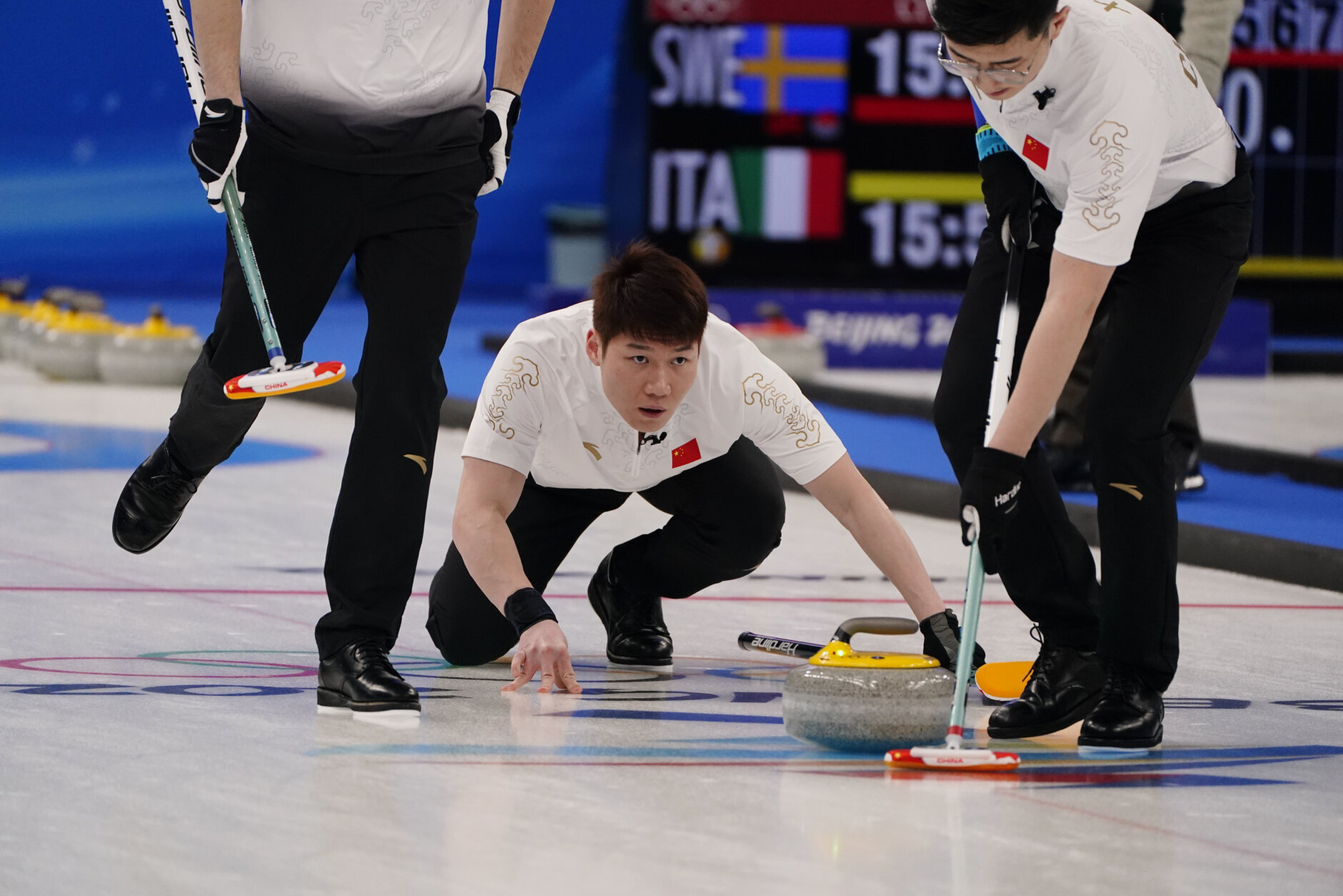 <p>China&#8217;s Wang Zhiyu throws a rock during a men&#8217;s curling match against Denmark at the Beijing Winter Olympics Friday, Feb. 11, 2022, in Beijing.</p>
