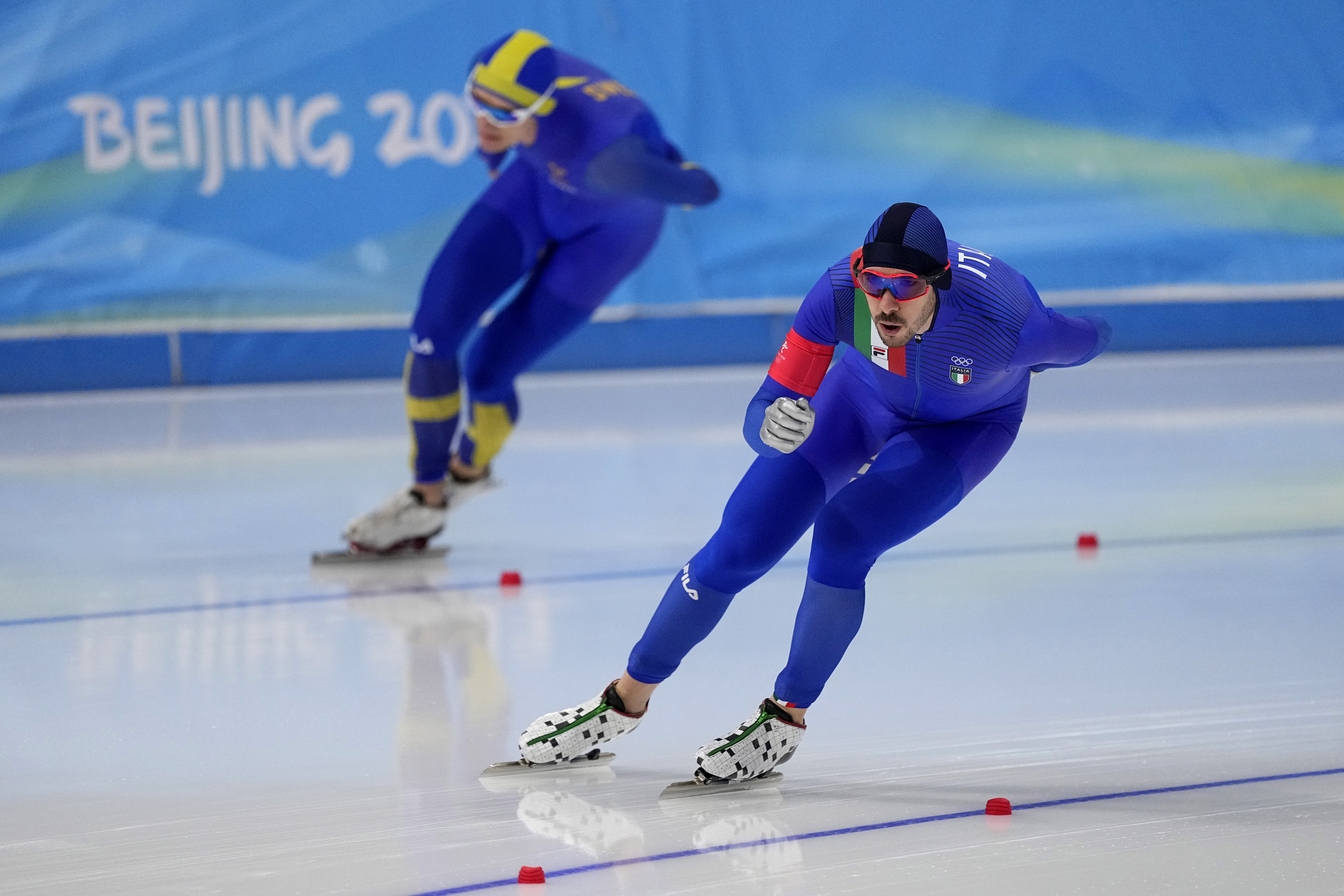 <p>Davide Ghiotto of Italy, foreground, competes against Nils van der Poel of Sweden in the men&#8217;s speedskating 10,000-meter race at the 2022 Winter Olympics, Friday, Feb. 11, 2022, in Beijing.</p>
