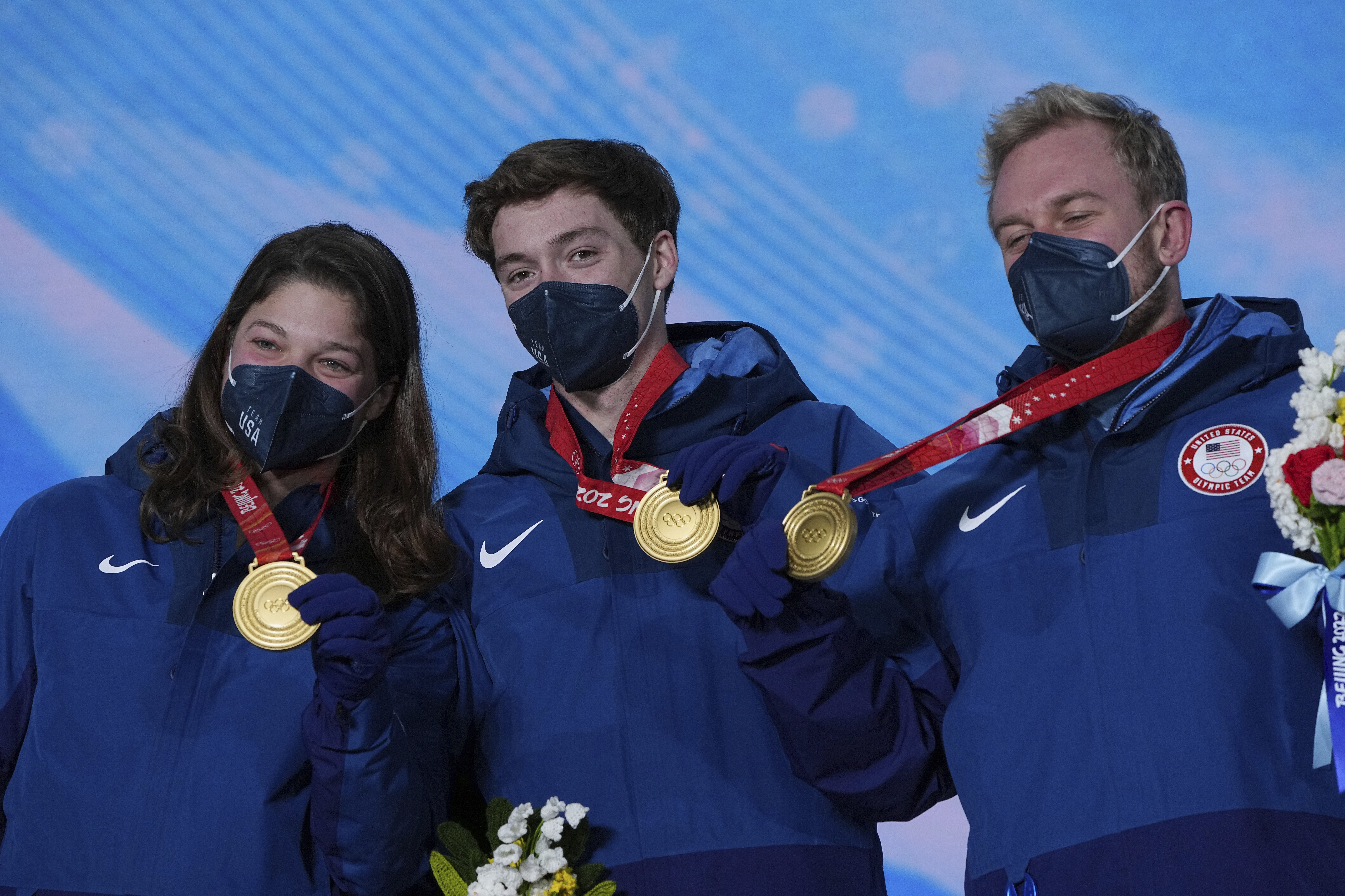<p>Gold medalists United States&#8217; Ashley Caldwell, Christopher Lillis and Justin Schoenefeld celebrate during a medal ceremony for the mixed team aerials at the 2022 Winter Olympics, Friday, Feb. 11, 2022, in Zhangjiakou, China.</p>
