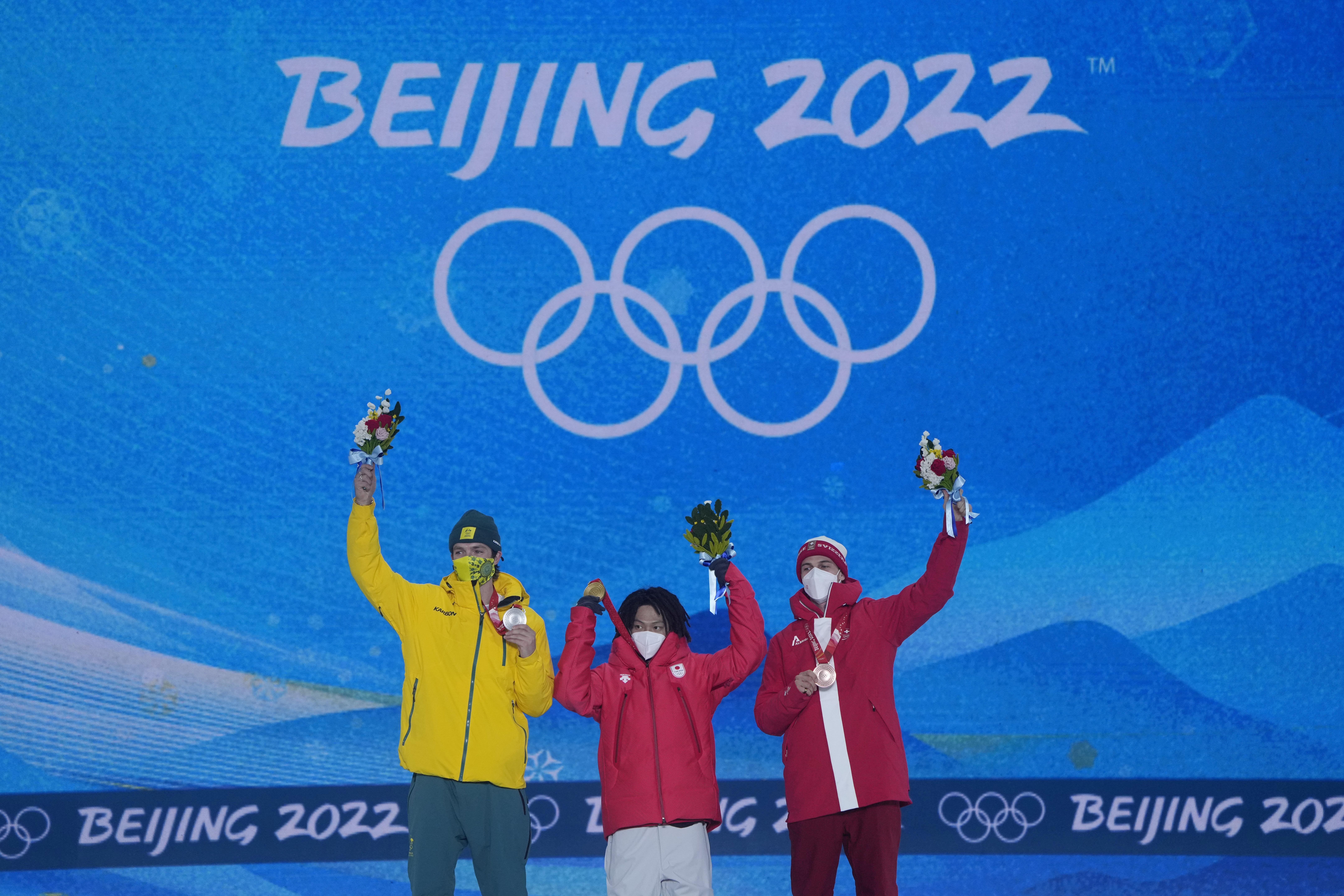 <p>From left silver medalist Australia&#8217;s Scotty James, gold medalist Japan&#8217;s Ayumu Hirano and bronze medalist Switzerland&#8217;s Jan Scherrer celebrate during a medal ceremony for the men&#8217;s halfpipe at the 2022 Winter Olympics, Friday, Feb. 11, 2022, in Zhangjiakou, China.</p>
