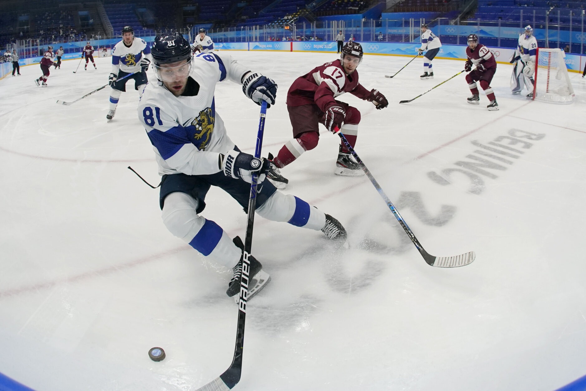 <p>Finland&#8217;s Iiro Pakarinen (81) beats Latvia&#8217;s Martins Dzierkals (17) to the puck during a preliminary round men&#8217;s hockey game at the 2022 Winter Olympics, Friday, Feb. 11, 2022, in Beijing.</p>
