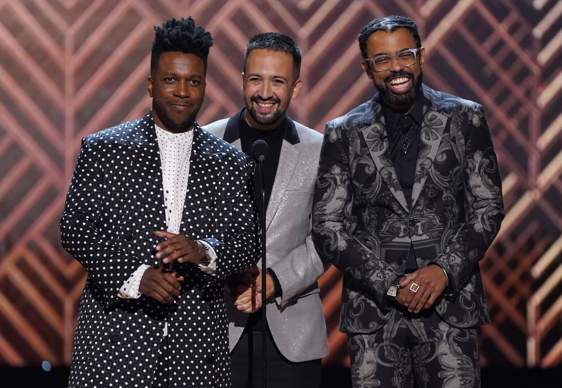 Leslie Odom Jr., from left, Lin-Manuel Miranda and Daveed Diggs speak at the 28th annual Screen Actors Guild Awards at the Barker Hangar on Sunday, Feb. 27, 2022 in Santa Monica, Calif.  (AP Photo/Chris Pizzello)