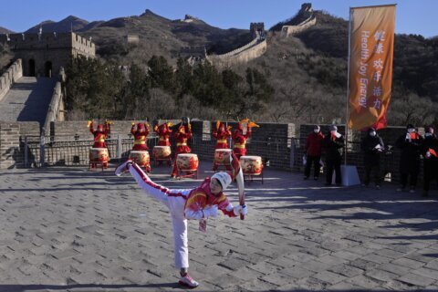 GLIMPSES: Shortened Olympic torch relay passes by Great Wall