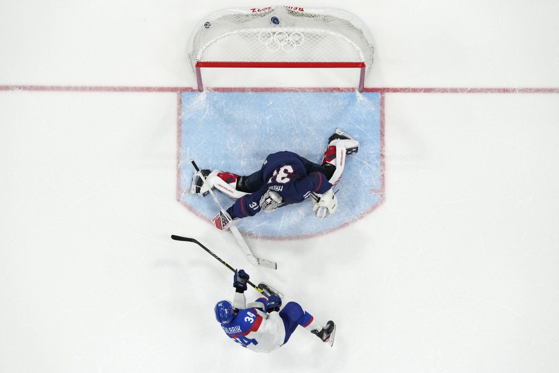 <p>Slovakia&#8217;s Peter Cehlarik (34) scores the winning goal past United States goalkeeper Strauss Mann (31) during a shoot-out in a men&#8217;s quarterfinal hockey game at the 2022 Winter Olympics, Wednesday, Feb. 16, 2022, in Beijing. Slovakia won 3-2.</p>
