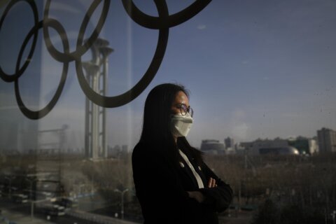 At Winter Olympics, virus fight waged with worker sacrifices