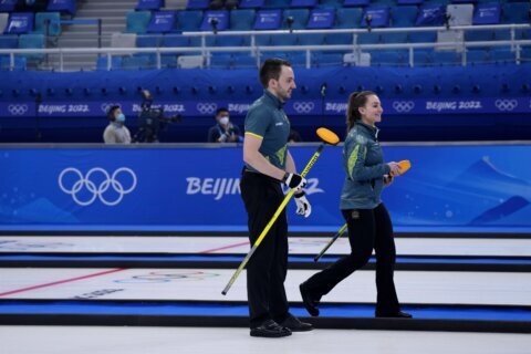 Aussies curlers out of Olympics, back in, then win 1st game