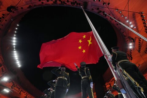 AP PHOTOS: Flags on display throughout Beijing Olympics