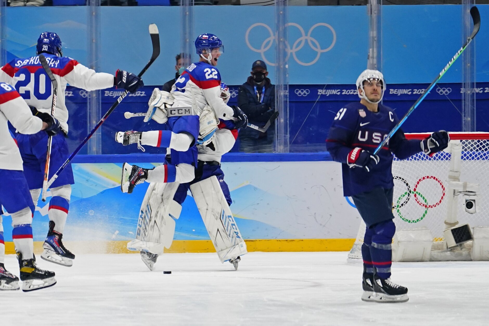<p>Slovakia&#8217;s Samuel Knazko (22) jumps onto goalkeeper Patrik Rybar after Rybar blocked the final shoot-out attempt by United States&#8217; Andy Miele, right, during a men&#8217;s quarterfinal hockey game at the 2022 Winter Olympics, Wednesday, Feb. 16, 2022, in Beijing. Slovakia won 3-2.</p>

