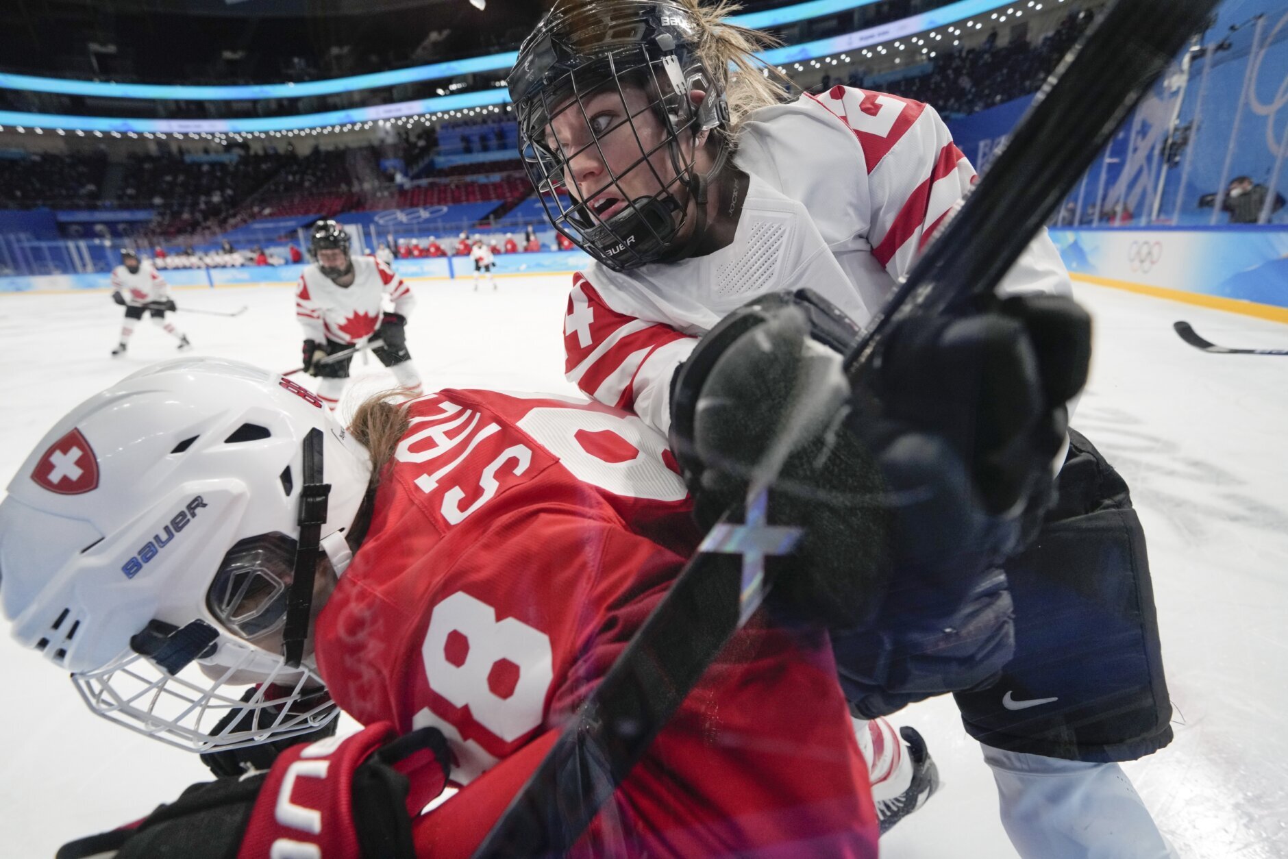 <p>Canada&#8217;s Natalie Spooner (24) checks Switzerland&#8217;s Phoebe Staenz (88) against the boards during a women&#8217;s semifinal hockey game at the 2022 Winter Olympics, Monday, Feb. 14, 2022, in Beijing.</p>
