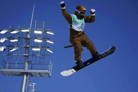 Injured Olympian gets big air in big-cat costume for kicks