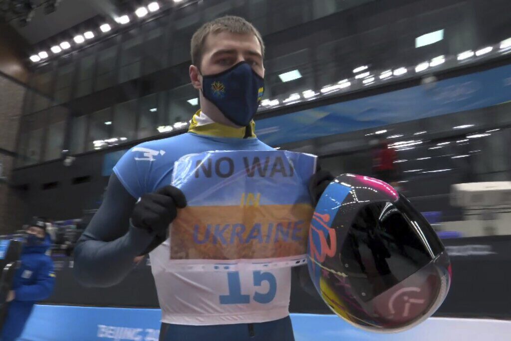 <p>In this frame from video, Vladyslav Heraskevych, of Ukraine, holds a sign that reads “No War in Ukraine” after finishing a run at the men’s skeleton competition at the 2022 Winter Olympics, Friday, Feb. 11, 2022, in the Yanqing district of Beijing.</p>
