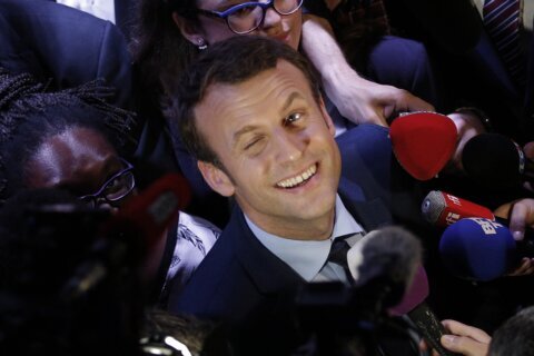 Macron not a candidate yet but campaigning for reelection