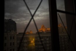 View of the sunset through windows that have been sealed to avoid the bursting of glass from possible shockwaves in central Kyiv, Ukraine, Monday, Feb. 28, 2022. (AP Photo/Emilio Morenatti)