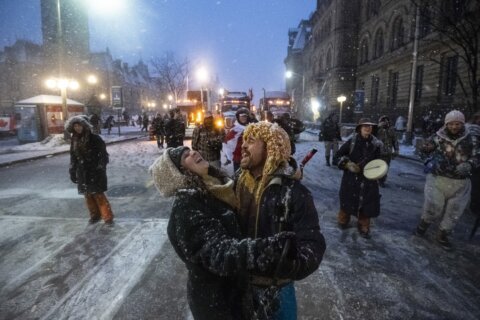 AP PHOTOS: Huddling around fires, dancing at Ottawa protest
