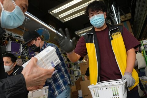 Hong Kong considers lockdown as daily infections top 34,000
