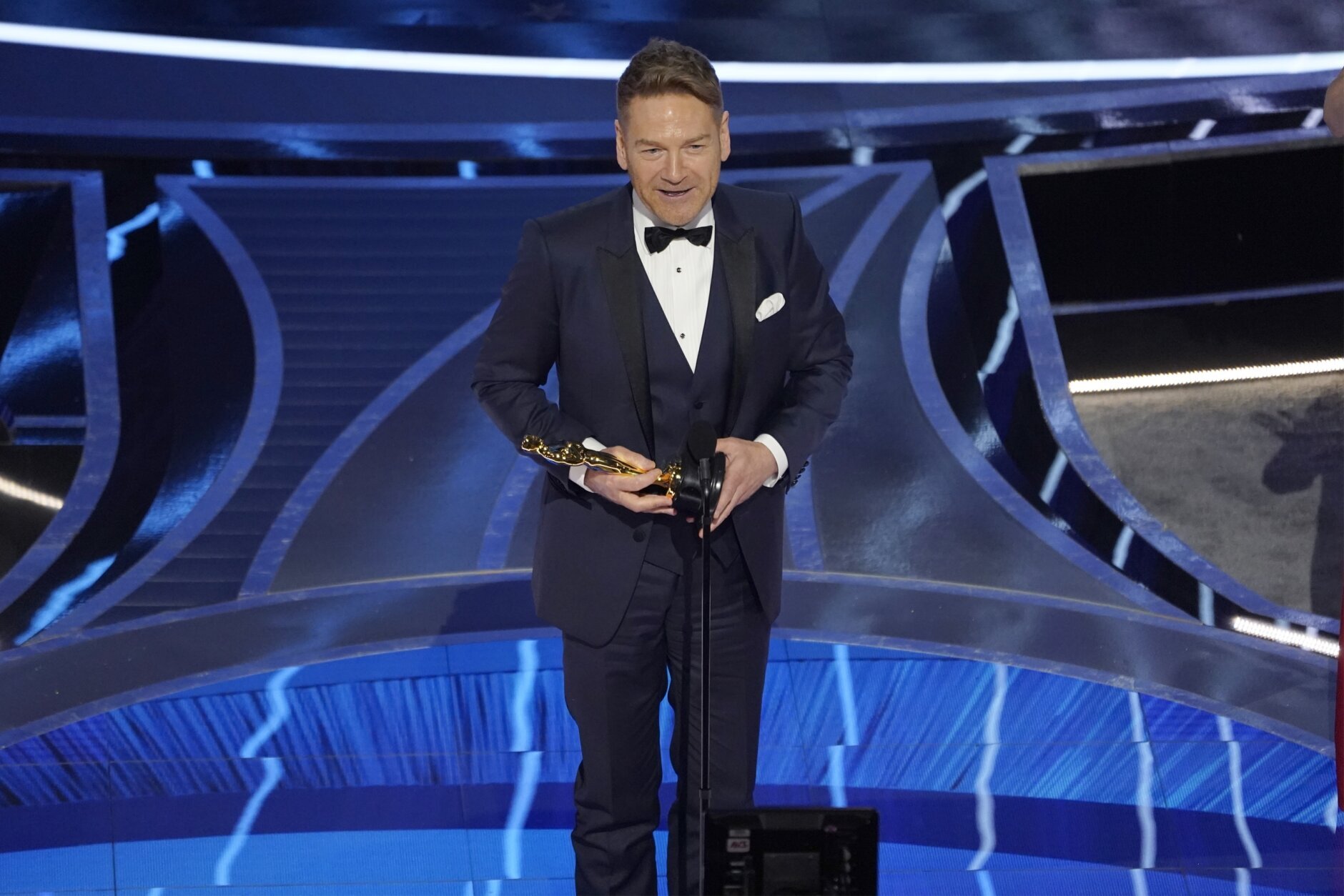 Kenneth Branagh accepts the award for best original screenplay for "Belfast" at the Oscars on Sunday, March 27, 2022, at the Dolby Theatre in Los Angeles. (AP Photo/Chris Pizzello)