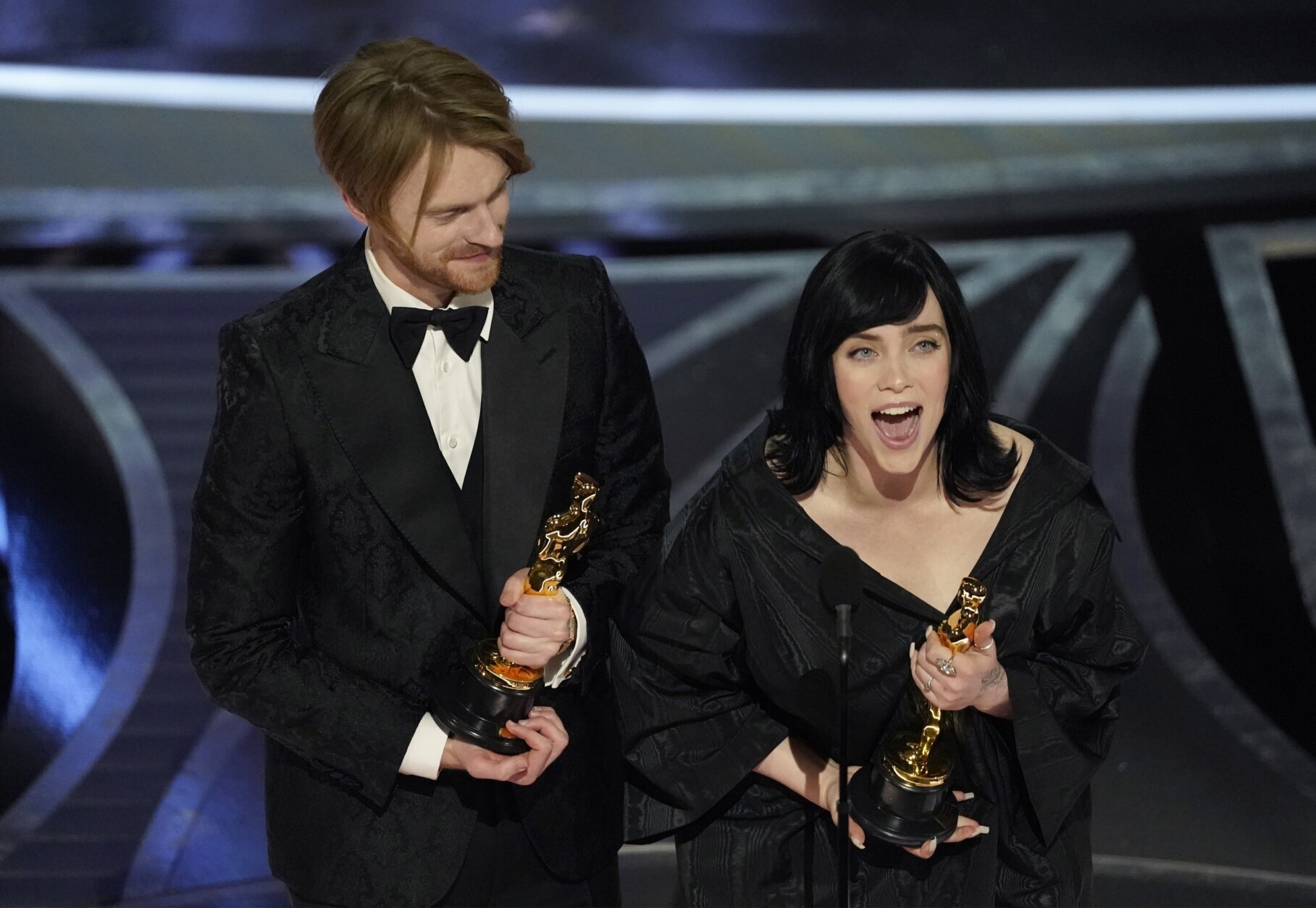 Billie Eilish, right, and Finneas O'Connell accept the award for best original song for "No Time To Die" from "No Time To Die" at the Oscars on Sunday, March 27, 2022, at the Dolby Theatre in Los Angeles. (AP Photo/Chris Pizzello)