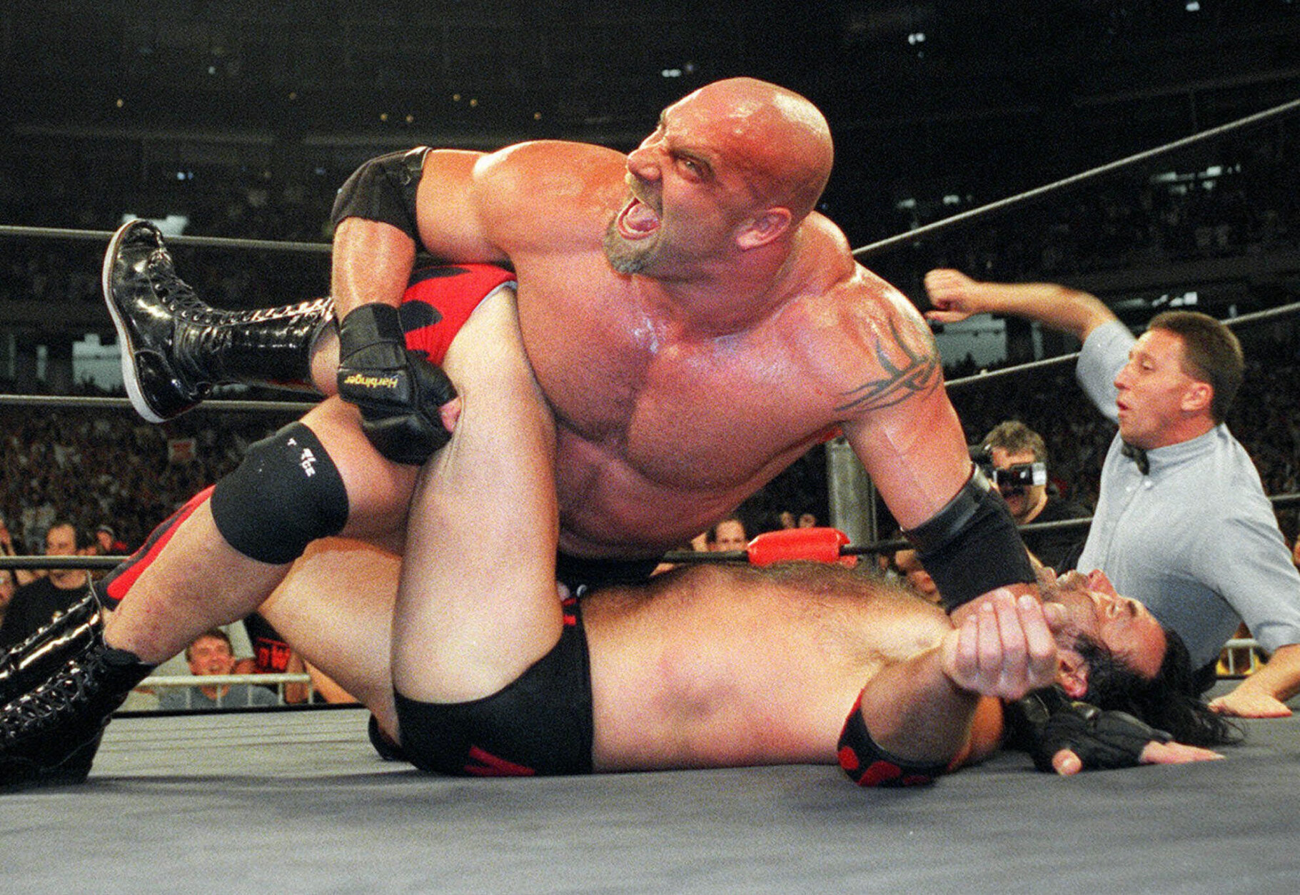 FILE - In this July 6, 1998, file photo, wrestling heavyweight champion Bill Goldberg puts Scott Hall to the mat during a match in Atlanta. Goldberg was seemingly retired, dabbling in acting, and far removed from the days of his reign as undefeated champion in WCW or WrestleMania winner for WWE. The 54-year-old Goldberg returns for his second match of the year when he challenges Bobby Lashley for the WWE title Saturday night, Aug. 21, 2021, at SummerSlam at Allegiant Stadium. (AP Photo/Erik S. Lesser, File)