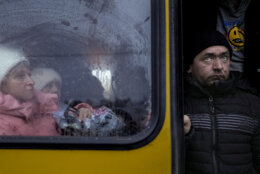 People who were evacuated from areas around the Ukrainian capital, wait on a bus after arriving at a triage point in Kyiv, Ukraine, Wednesday, March 9, 2022. A Russian airstrike devastated a maternity hospital Wednesday in the besieged port city of Mariupol amid growing warnings from the West that Moscow's invasion is about to take a more brutal and indiscriminate turn. (AP Photo/Vadim Ghirda)