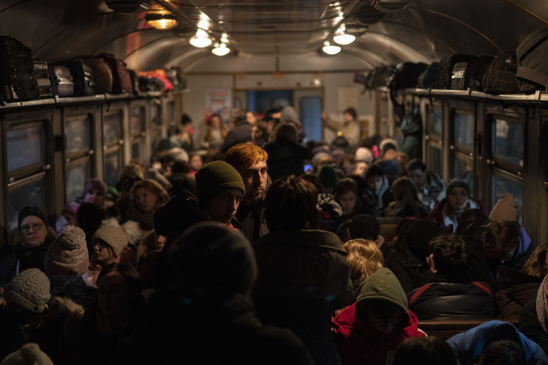<p>Displaced Ukrainians onboard a Poland bound train in Lviv, western Ukraine, Sunday, March 13, 2022. Lviv in western Ukraine itself so far has been spared the scale of destruction unfolding to its east and south. The city&#8217;s population of 721,000 has swelled during the war with residents escaping bombarded population centers and as a waystation for the nearly 2.6 million people who have fled the country.</p>
