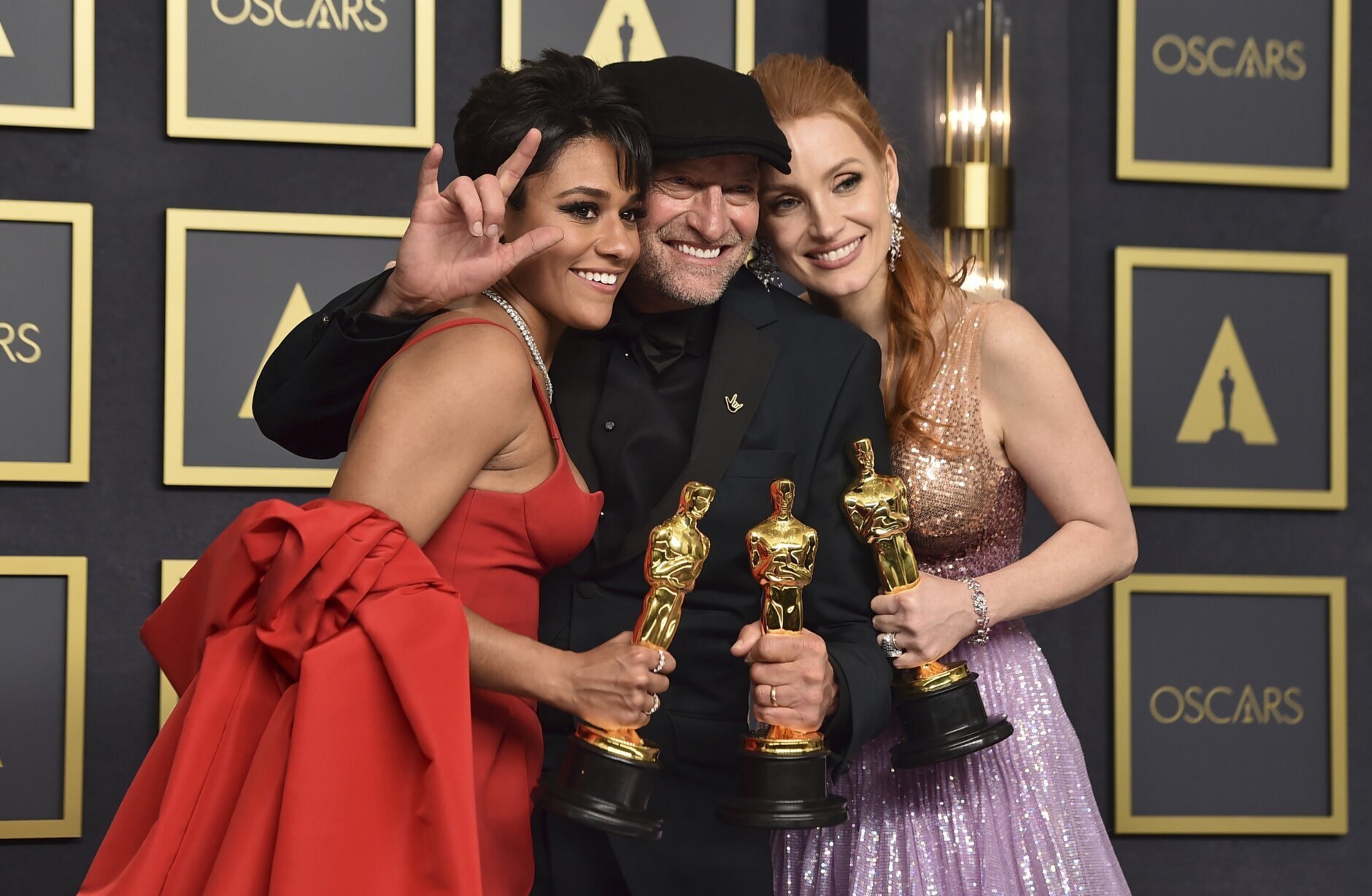 Ariana DeBose, from left, winner of the award for best performance by an actress in a supporting role for "West Side Story, Troy Kotsur, winner of the award for best performance by an actor in a supporting role for "CODA", and Jessica Chastain, winner of the award for best performance by an actress in a leading role for "The Eyes of Tammy Faye," pose in the press room at the Oscars on Sunday, March 27, 2022, at the Dolby Theatre in Los Angeles. (Photo by Jordan Strauss/Invision/AP)